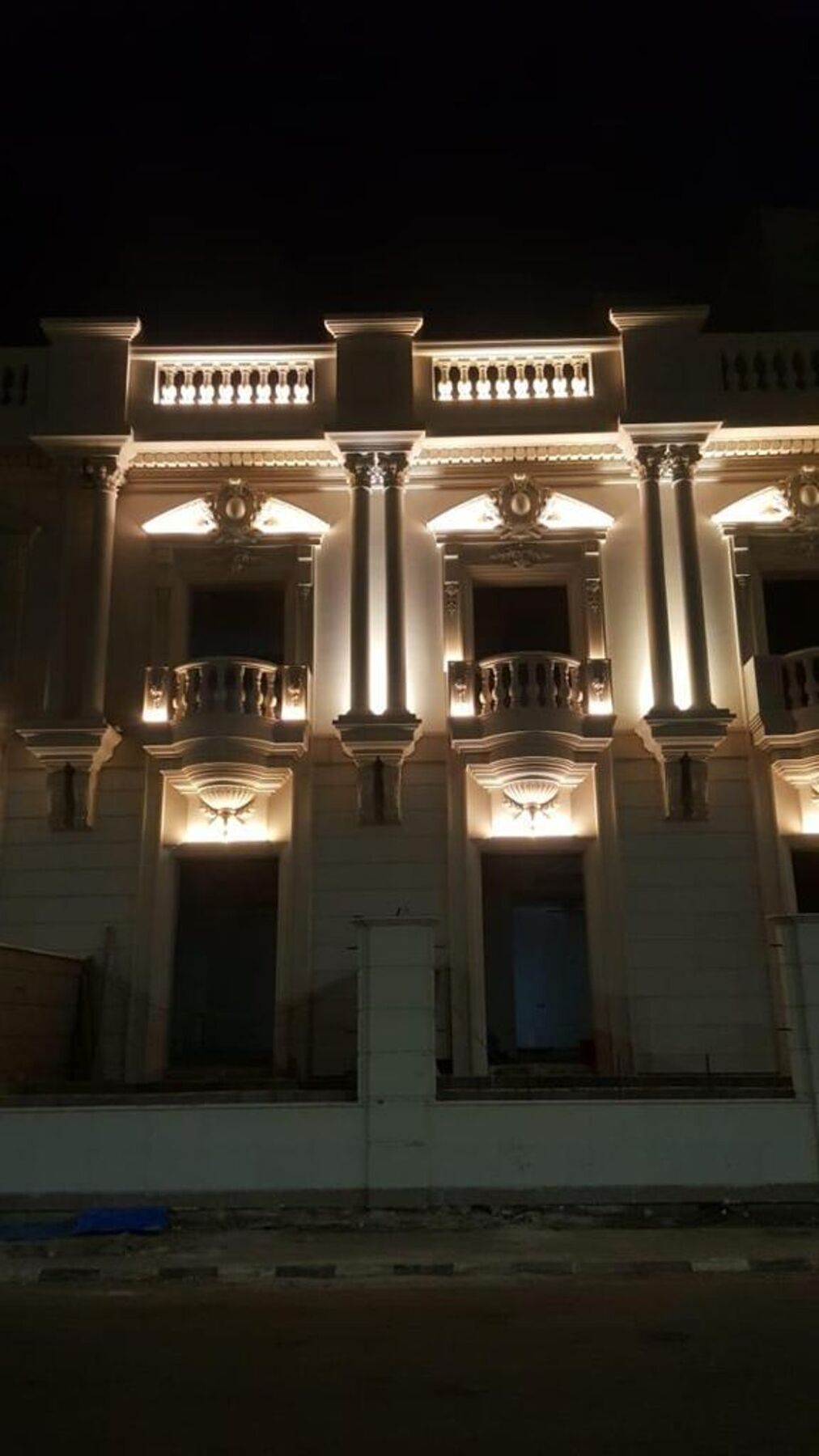 Classical palace facade with uplit columns, Saudi Arabia